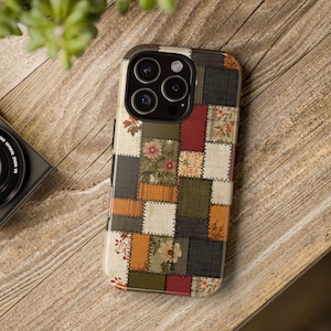 May include: A patchwork-style phone case featuring a mix of floral and geometric patterns in shades of beige, brown, green, and red. The case has a textured appearance and a protective design, suitable for a smartphone.