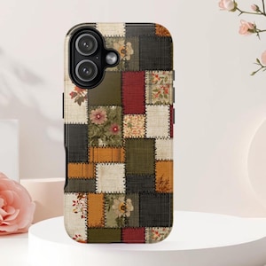 May include: A rectangular smartphone case featuring a patchwork design of various fabric textures and colors including olive green, deep red, mustard yellow, and cream. The pattern includes floral motifs and stitched borders between each square section.