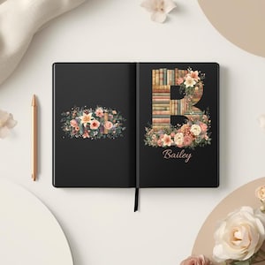May include: Black journal with floral and book design. The open journal features a floral arrangement on the left page and a large letter "B" made of books and flowers on the right page. The name "Bailey" is written below the letter.