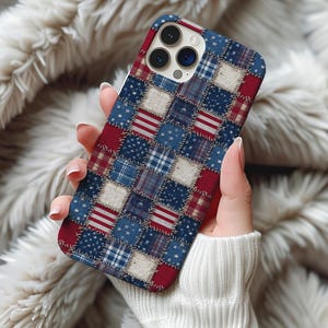 May include: A phone case with a patchwork design featuring red, white, and blue squares. The squares display stars, stripes, and plaid patterns, creating a patriotic aesthetic. The case is held in a person's hand.