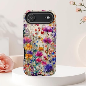 May include: A phone case featuring a vibrant floral design. The case showcases a variety of colorful flowers, including purple, orange, and blue blooms, set against a light background. The case has a camera cutout and a sleek, modern design.