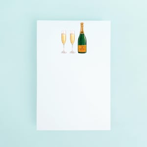 May include: Watercolor illustration of a green champagne bottle and two champagne flutes filled with bubbly liquid. The bottle has a gold foil label. The flutes are slender with delicate stems. The image is on a white background.