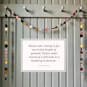 May include: A decorative garland featuring circular and oval fabric pieces in various patterns and colors, strung together. The garland is approximately 6 feet long. The text in the image reads: "Please note: listing is for one 6 foot length of garland."
