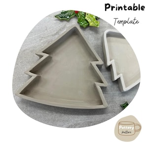 May include: A grey ceramic Christmas tree mould for pottery. The mould is in two pieces and is ready to be used to create a unique Christmas tree ornament.