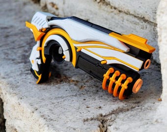 May include: A white and orange 3D printed toy gun with a black barrel and a textured surface.