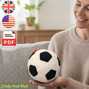 May include: A crocheted soccer ball in black and white, held in someone's hands. The ball has a classic pentagon design. The image also includes a PDF icon, and the text "Linda And Med".