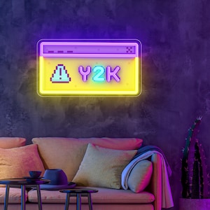 May include: A neon sign in the shape of a retro computer window, with the text "Y2K" in pixelated font. The sign has a yellow background and a purple border, and is mounted on a dark purple wall. The sign is illuminated with bright neon lights.