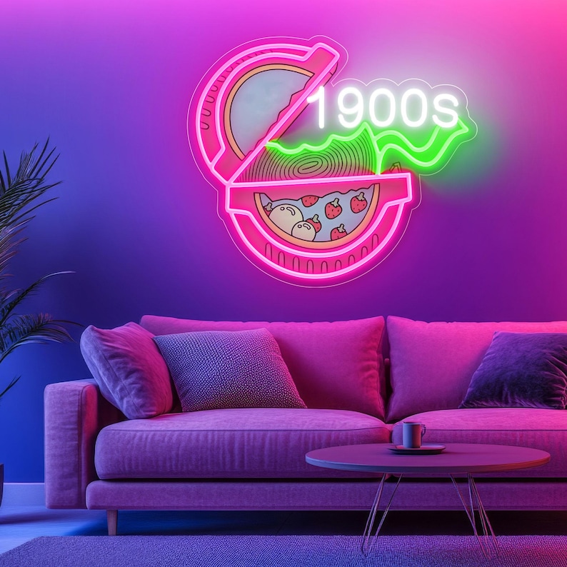 May include: A neon sign in pink and green, shaped like a pizza slice with the text "1900s". The sign is mounted on a purple wall above a pink sofa with pillows and a small table.