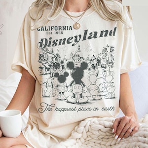 May include: A set of three ceramic mugs with a speckled, matte finish. The mugs are in shades of cream, light gray, and dark gray. Each mug has a simple, minimalist design, perfect for coffee or tea.