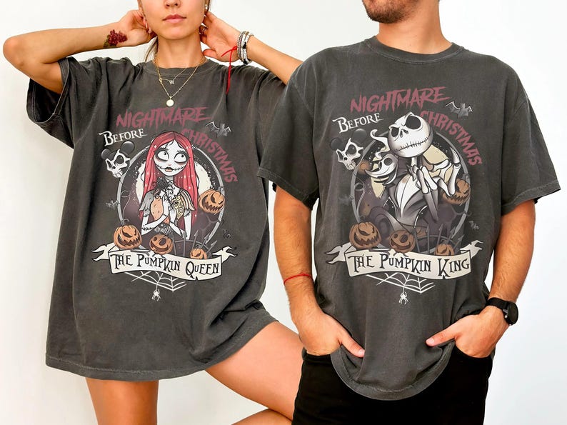 May include: Two dark gray t-shirts featuring characters from "The Nightmare Before Christmas." One shirt displays Sally, pumpkins, and the text "The Pumpkin Queen." The other shows Jack Skellington, pumpkins, and "The Pumpkin King."