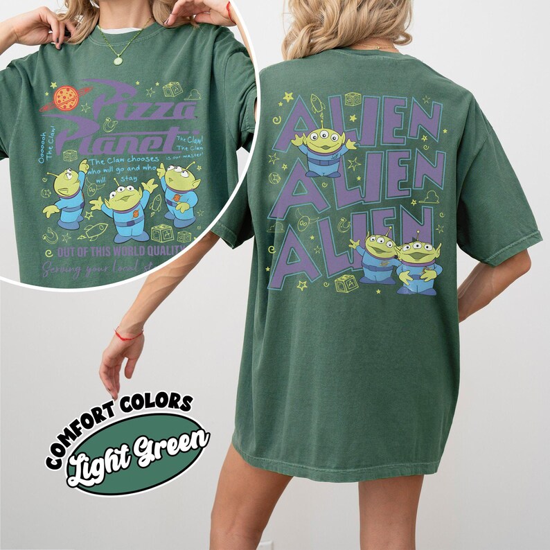 May include: Green t-shirt with a Pizza Planet graphic on the front and Alien characters on the back. The front design includes the Pizza Planet logo and cartoon aliens. The back features the word "ALIEN" repeated three times with alien characters.