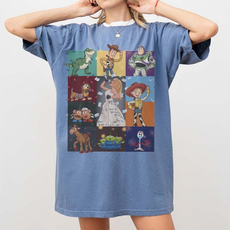 May include: A blue short-sleeve t-shirt featuring a grid of Toy Story character illustrations, including Rex, Woody, Buzz Lightyear, Slinky Dog, Bo Peep, Mr. and Mrs. Potato Head, Bullseye, the Aliens, and Forky, with a central figure in a white dress.