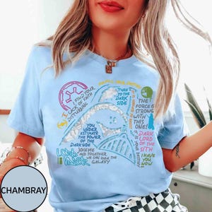 May include: Pale blue t-shirt with a Darth Vader graphic and quotes from Star Wars. The design includes phrases such as "Turn to the Dark Side" and "The Force is Strong with this One!"