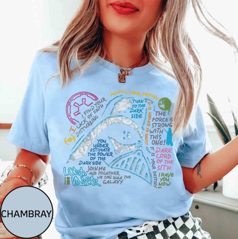 May include: Pale blue t-shirt with a Darth Vader graphic and quotes from Star Wars. The design includes phrases such as "Turn to the Dark Side" and "The Force is Strong with this One!"