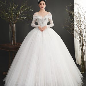 Beautiful sparkling princess wedding dress. Luxurious long-sleeved princess wedding dress. Custom wedding dress upon request.