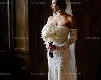 Meticulously hand beaded mermaid wedding dress. Strapless corset wedding dress with long sleeves. Custom wedding dress upon request.