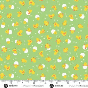 May include: A light green fabric featuring a repeating pattern of yellow chicks, white cracked eggs, and small white footprints. The chicks are in various poses, some emerging from eggs. The fabric has a ruler along the bottom with the Andover Fabrics logo.
