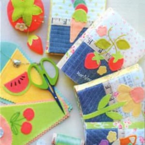 May include: A collection of sewing accessories and supplies, including needlebooks, scissor cases, and a tomato pincushion. The image features colorful felt fruit designs, scissors, and spools of thread. Text reads "Sewing Goodies."