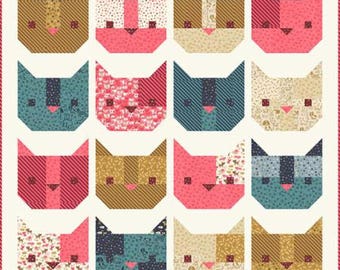 May include: A patchwork quilt featuring sixteen stylized cat faces in various colors and patterns. The cats have triangular ears, pink noses, and are set against a cream background with a red border. The quilt showcases a variety of fabrics.