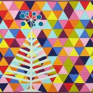 May include: A colorful quilt with a geometric design. The quilt features a pattern of triangles in various colors, including red, orange, yellow, pink, blue, and purple. A white tree-like shape with blue accents is in the center.