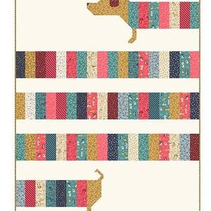May include: A quilt featuring a dachshund dog design. The dog's body is made of colorful fabric strips in shades of pink, teal, gold, and navy. The background is a cream color. The text "Dorothy Prudie Fabrics" is at the bottom.
