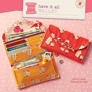 May include: Open wallet with multiple compartments, filled with cash, credit cards, and coins. A closed red wallet with white floral pattern and a bow is next to it. The text "have it all WALLET" is visible.