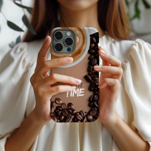 May include: A brown and beige phone case with a coffee cup and coffee beans. The case has the text "Coffee Time" on it.