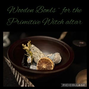 May include: A dark brown wooden bowl filled with dried herbs, a dried orange slice, and other natural elements. The text "Wooden Bowls ~ for the Primitive Witch altar" is written in green script above the bowl.