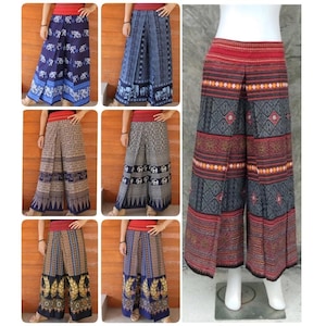 May include: Collection of wide-leg pants with various patterns. The pants feature designs with elephants, geometric shapes, and floral motifs. Colors include blue, brown, and black, with red waistbands. The pants are made of a lightweight fabric.
