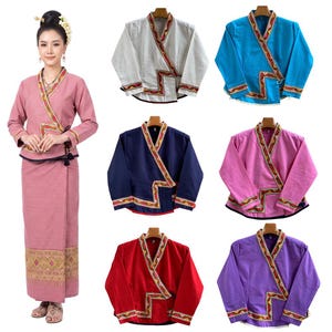 May include: A collection of long-sleeved wrap jackets in white, blue, navy, pink, red, and purple, each featuring a V-neckline and a decorative patterned trim along the front opening and cuffs. A matching pink wrap skirt is also displayed.