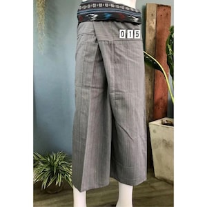 May include: Gray wrap pants with a patterned waistband. The pants have a striped pattern and a tag that says "015".
