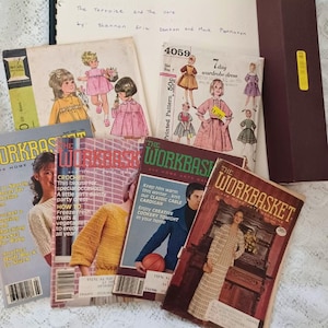 May include: A collection of vintage sewing patterns and magazines, including "The Workbasket" and McCall's patterns. The image features illustrations of children's clothing and crochet projects, with handwritten text at the top.