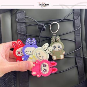Llavero de Labubu sentado, bonito dije de anime kawaii, accesorio para mochila infantil, llavero para niña, regalo de regreso a clases, llavero kawaii, dibujos animados