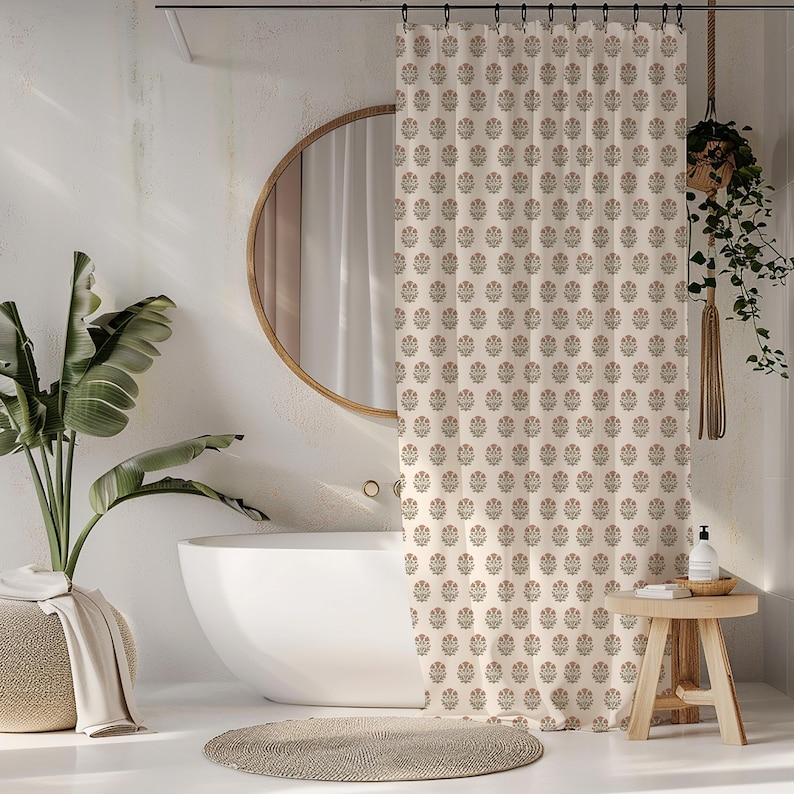 May include: Cream-colored floral patterned shower curtain in a bathroom setting. The curtain features a repeating pattern of stylized flowers in muted red and green. A round mirror and a white bathtub are also visible.
