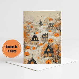 May include: Halloween-themed greeting card with a watercolour illustration of a village with houses, pumpkins, and bare trees. The card is on a white background. The text "Comes in 4 Sizes" is on an orange circle.