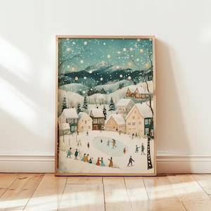 May include: A framed winter scene print depicts a snowy village with people ice skating and playing. The artwork features a light blue sky, snow-covered mountains, and houses with warm, inviting lights. The print is in a wooden frame.