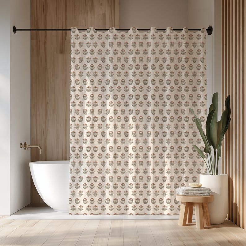 May include: Cream-colored shower curtain with a repeating floral pattern in muted red and gray. The curtain hangs in front of a white bathtub, with a wooden stool and potted plant nearby. The bathroom has wooden paneling.
