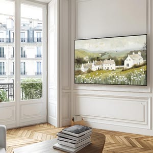 May include: A painting depicting a white farmhouse nestled amongst rolling green hills. The farmhouse is surrounded by a field of white flowers. The painting is framed in black.