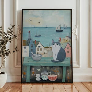 May include: A painting depicting a cat perched on a wooden table overlooking a seascape. The cat is white and grey with blue eyes. The table is painted a light blue-green colour and features a bowl of white and blue ceramic. The seascape is painted in shades of blue and green with a few sailboats in the distance.