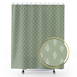 May include: Sage green shower curtain with a repeating white floral pattern. A circular inset shows a close-up of the floral design. The curtain hangs from a metal rod with silver hooks.