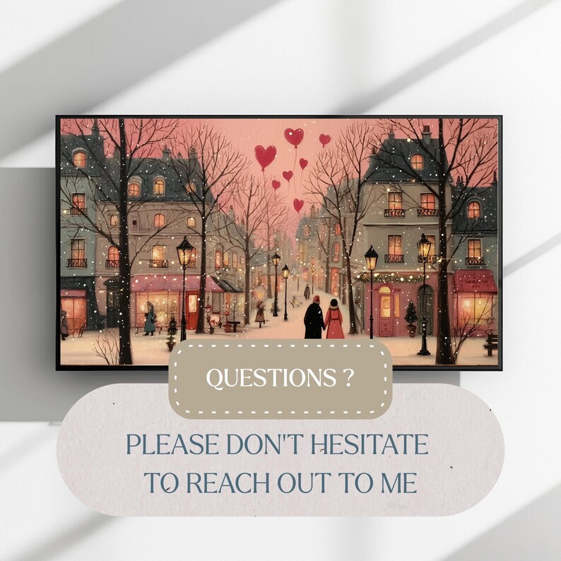 May include: A framed print of a romantic winter scene. The artwork depicts a European street with buildings, streetlights, and a couple walking. Red heart-shaped balloons float in the pink sky. The text "QUESTIONS? PLEASE DON'T HESITATE TO REACH OUT TO ME" is at the bottom.