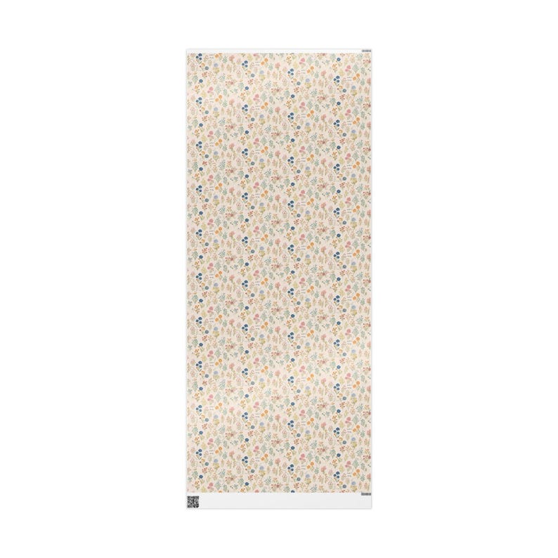 May include: A rectangular wallpaper roll featuring a repeating pattern of small, colourful floral and leaf designs on a cream background. The pattern includes blue, pink, and yellow elements. The roll is vertically oriented.