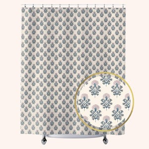 May include: A shower curtain featuring a repeating floral pattern of dark blue stems and leaves with light pink thistle-like flower heads on a cream background. A circular inset highlights the detailed botanical print in a larger scale.