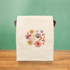 A Stylish Floral Canvas Lunch Tote with a soft watercolor design, perfect for daily use at school, the office, or park picnics.