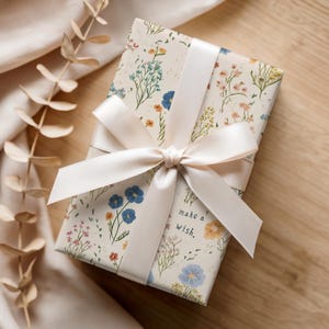 Floral birthday wrapping paper with playful vintage design in soft neutral shades, ideal for presents and special occasion decor.