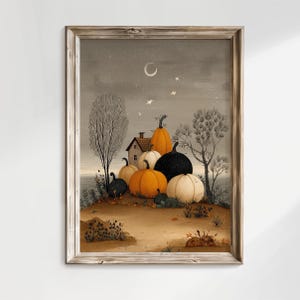 May include: A framed print depicting an autumnal landscape. A cottage is nestled on a hill, surrounded by pumpkins in orange, black, and white. The sky is grey with a crescent moon and stars.
