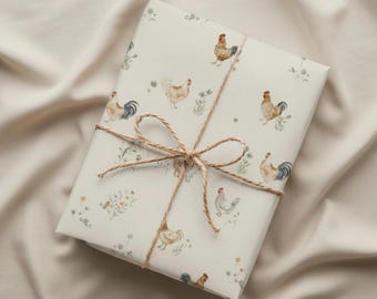 May include: A wrapped gift with cream-colored paper featuring a repeating pattern of watercolor chickens and wildflowers. The package is tied with twine, forming a bow. The background is a neutral, textured fabric.