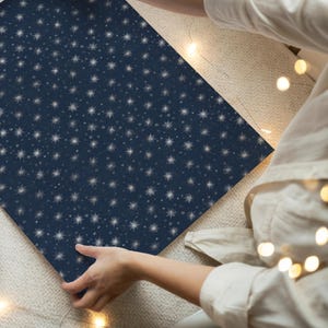 Elegant dark blue Noel gift wrap decorated with silver stars, vintage inspired paper for Christmas presents