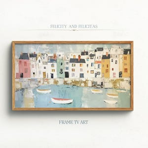 May include: A framed painting of a colorful row of houses along a waterfront with boats in the water. The title "Felicity and Felicitas" is written at the top of the painting.