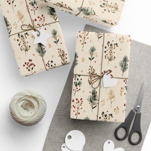 DIY gift wrap paper with botanical Christmas tree branch artwork, a stylish and natural holiday packaging idea.